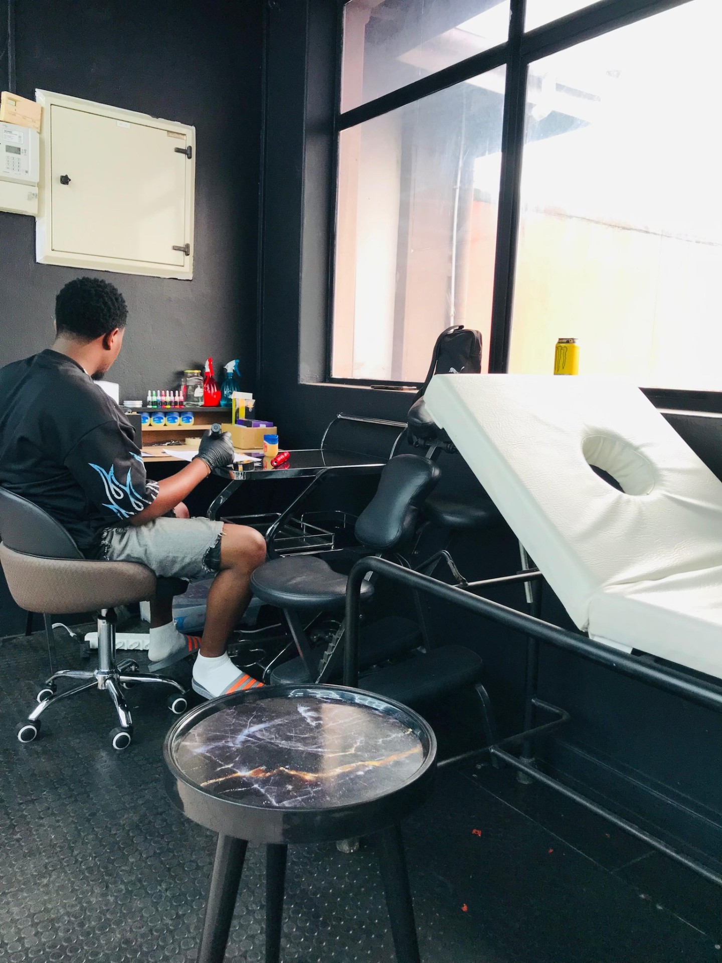 Tattoo artist at work in the Rustle Ink studio